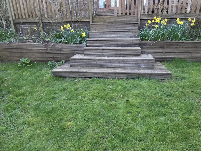 Grey weathered timber decking steps before cleaning